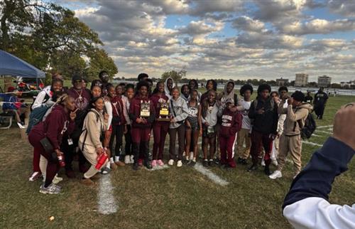 RHS boys and girls cross country team standing on grass at Belle Isle